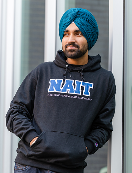 NAIT Student Wearing Program Campus Hoodie