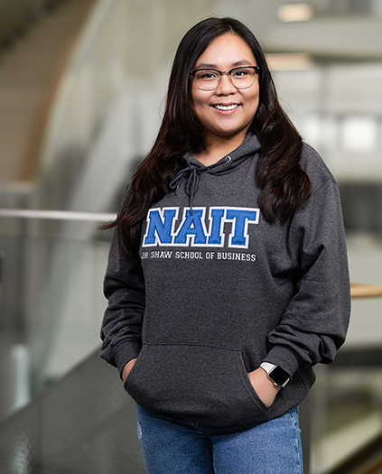 NAIT Student Wearing Program Campus Hoodie