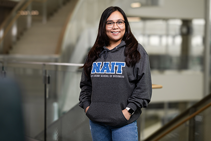 NAIT Student Wearing Program Campus Hoodie