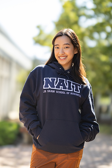 NAIT Student Wearing Program Campus Hoodie